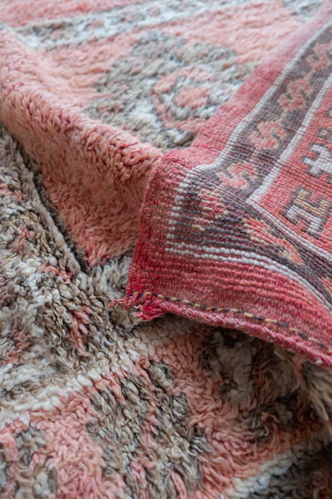 Vintage Moroccan rug  featuring neutral colors and intricate tribal motifs.