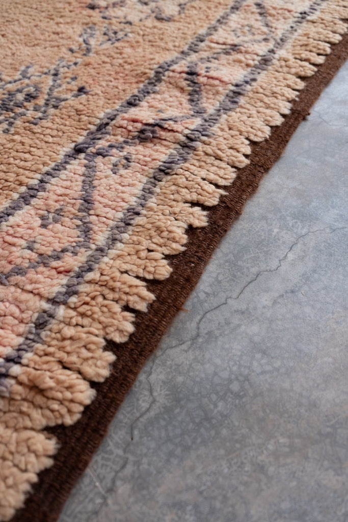 Vintage Moroccan rug displaying intricate tribal patterns.