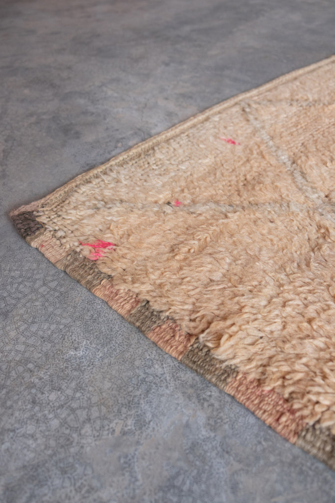 A stunning vintage Moroccan rug  showcasing traditional tribal patterns, available at Moroccan Tribe.