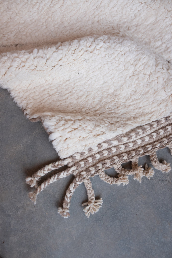 Contemporary Moroccan rug showcasing traditional motifs and a blend of neutral hues.