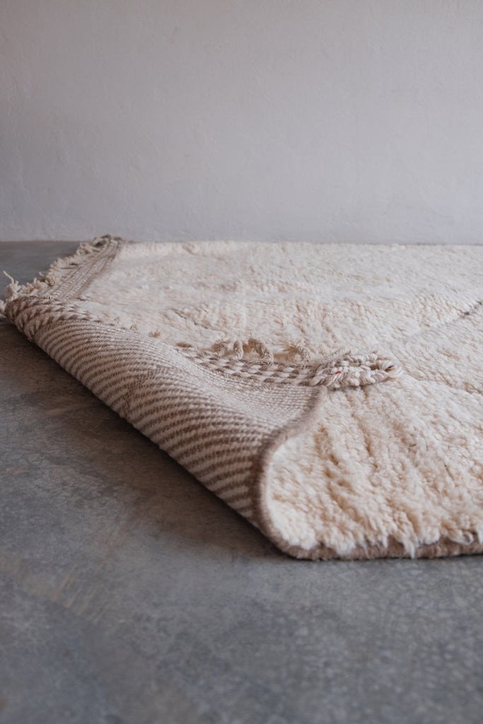 Contemporary Moroccan rug  displaying intricate patterns and neutral colors.