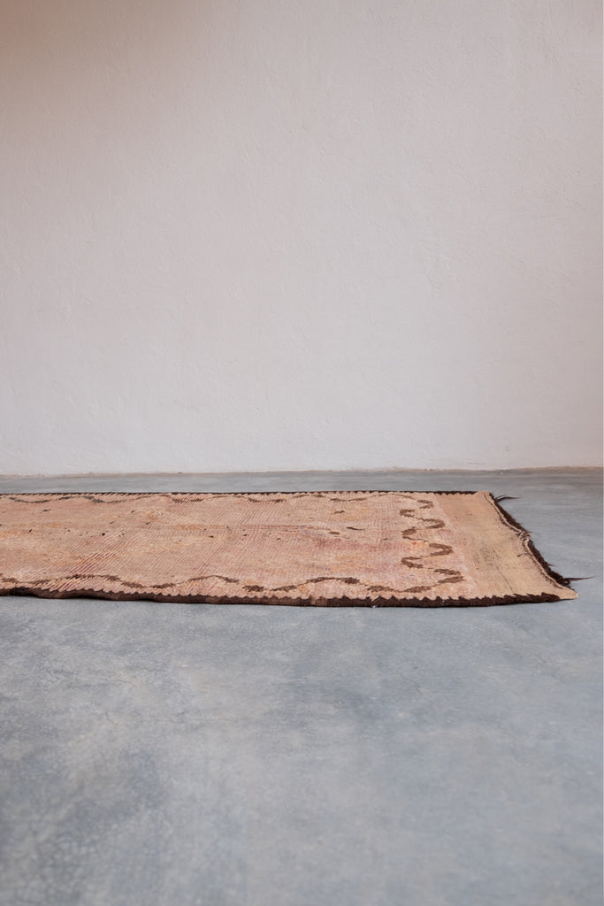 Vintage Moroccan rug displaying intricate tribal patterns.