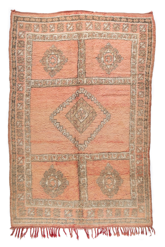 A stunning soft and cozy vintage Moroccan rug with beautiful geometric patterns and neutral colors, a statement piece offered by Moroccan Tribe.