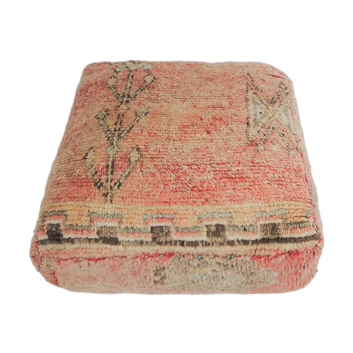 Vintage Moroccan floor cushion with faded pink and aqua details.